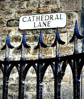 Section of St Mary's Cathedral railings with Cathedral Lane street-name sign in the background.