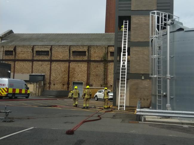 Fire-fighters with taking a hose up the tower in the McDonald Road Fire station drill yard.